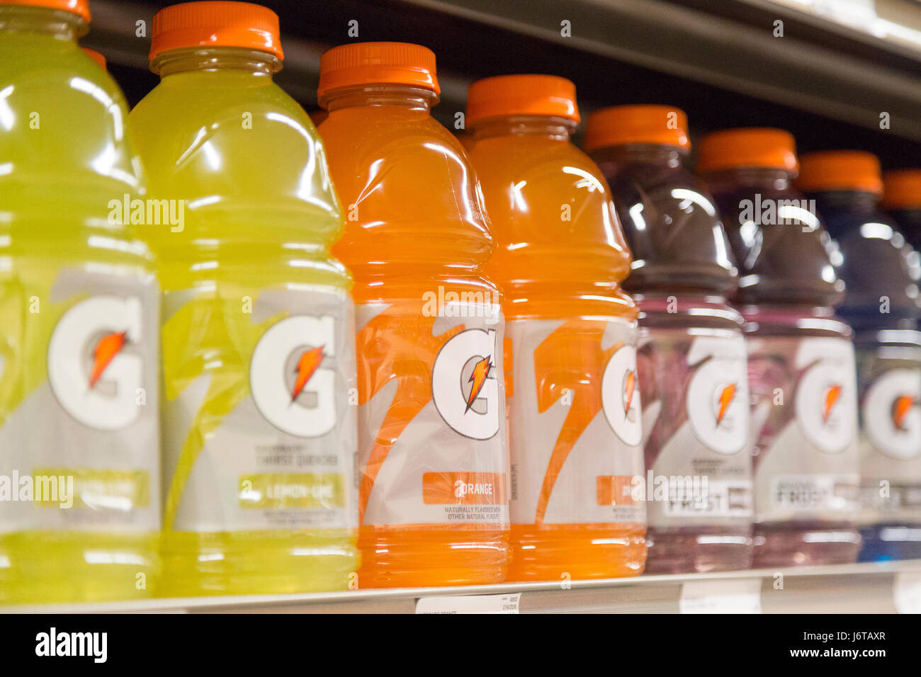 bottles of different flavored Gatorade for sale on the shelves of a