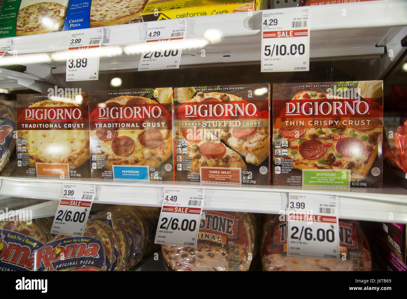 a display of DiGiorno frozen pizzas in a glass freezer case at a grocery store Stock Photo