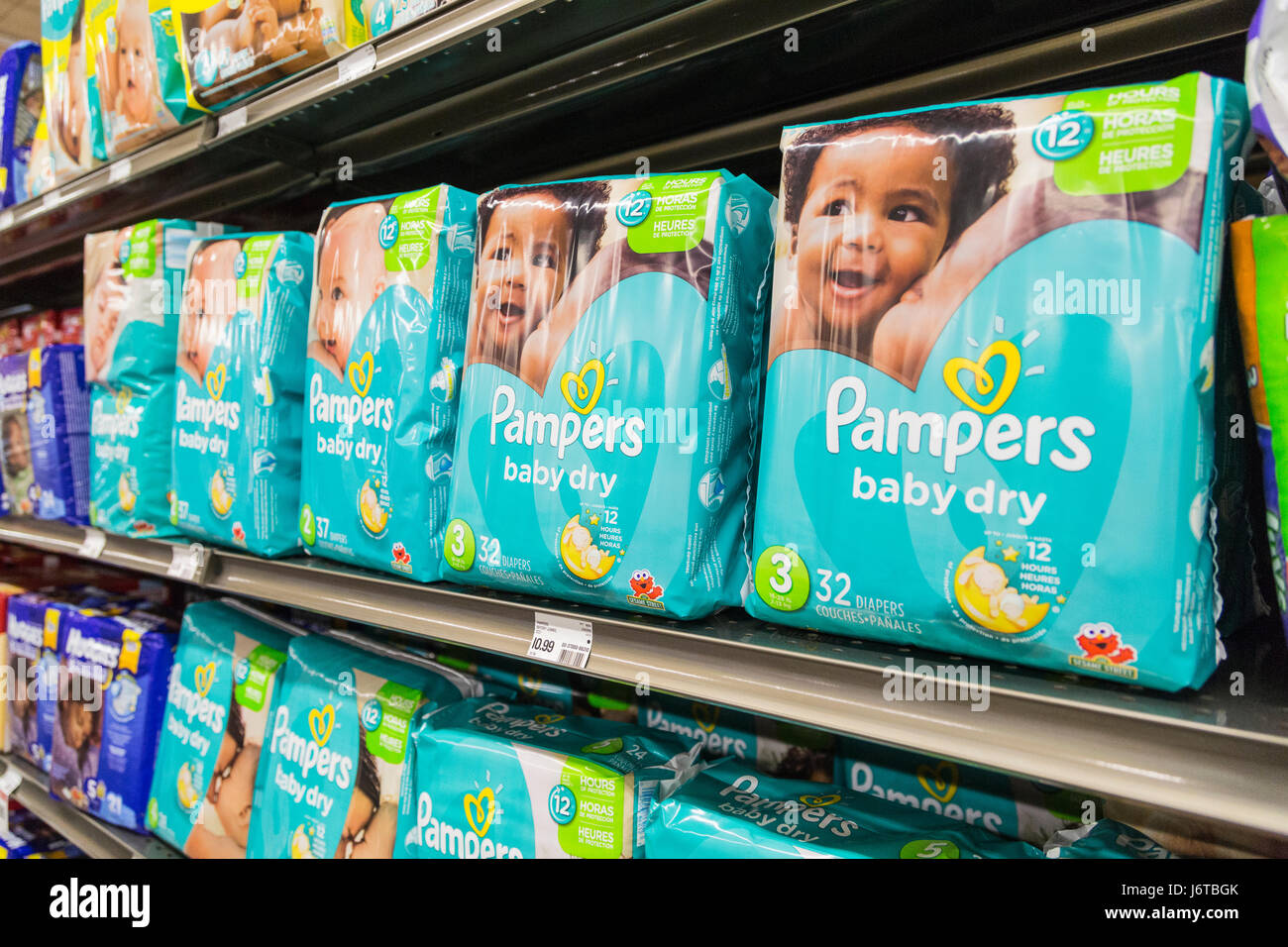 packages of Pampers brand diapers on a shelf of a grocery store Stock Photo