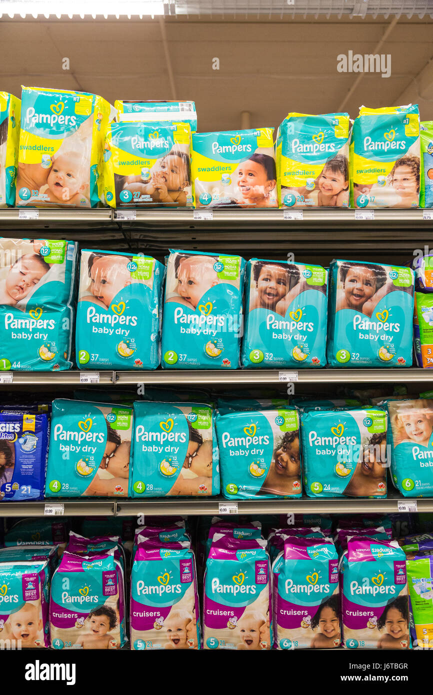 packages of Pampers brand diapers on a shelf of a grocery store Stock Photo