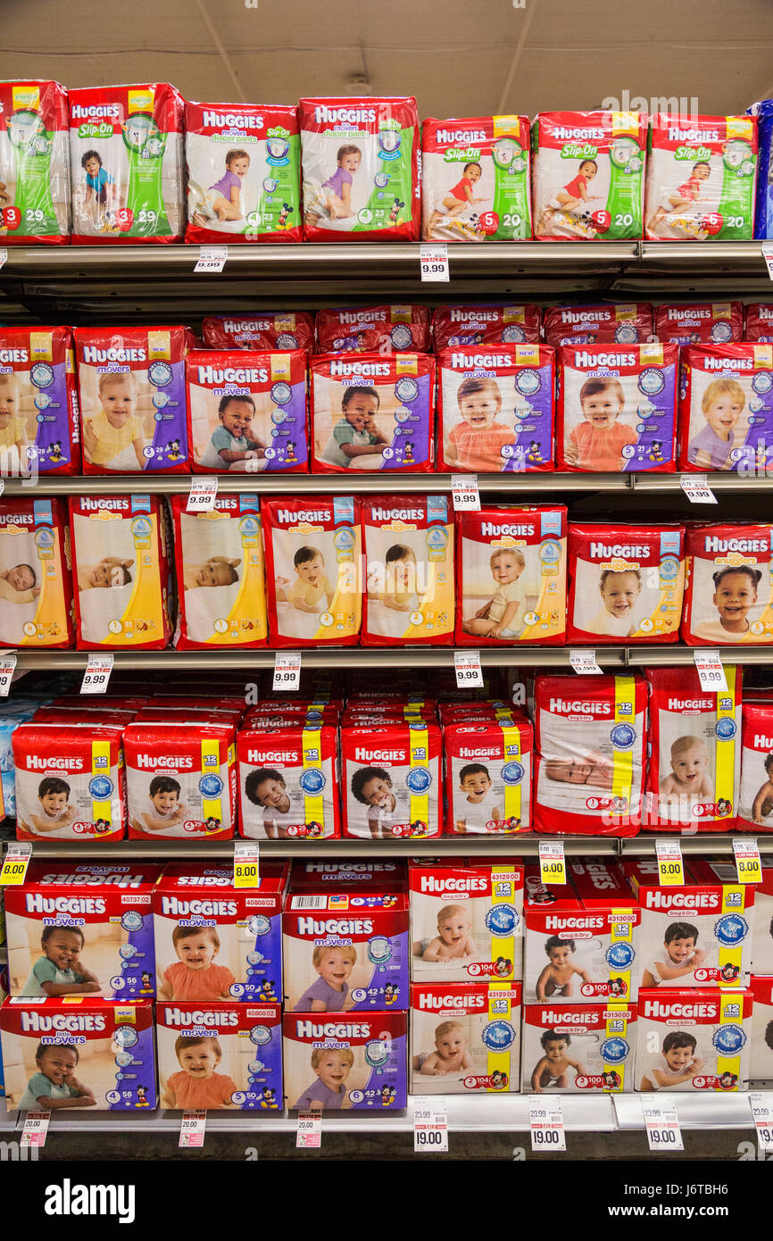 packages of Huggies brand diapers on a shelf of a grocery store Stock Photo