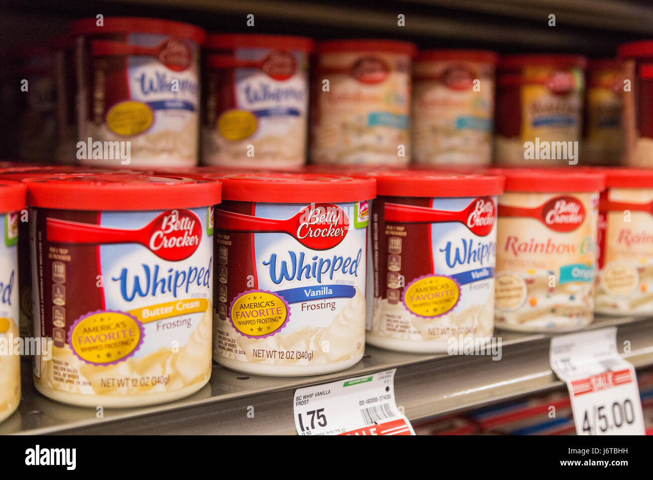 containers of Betty Crocker brand frosting on the shelf of a grocery