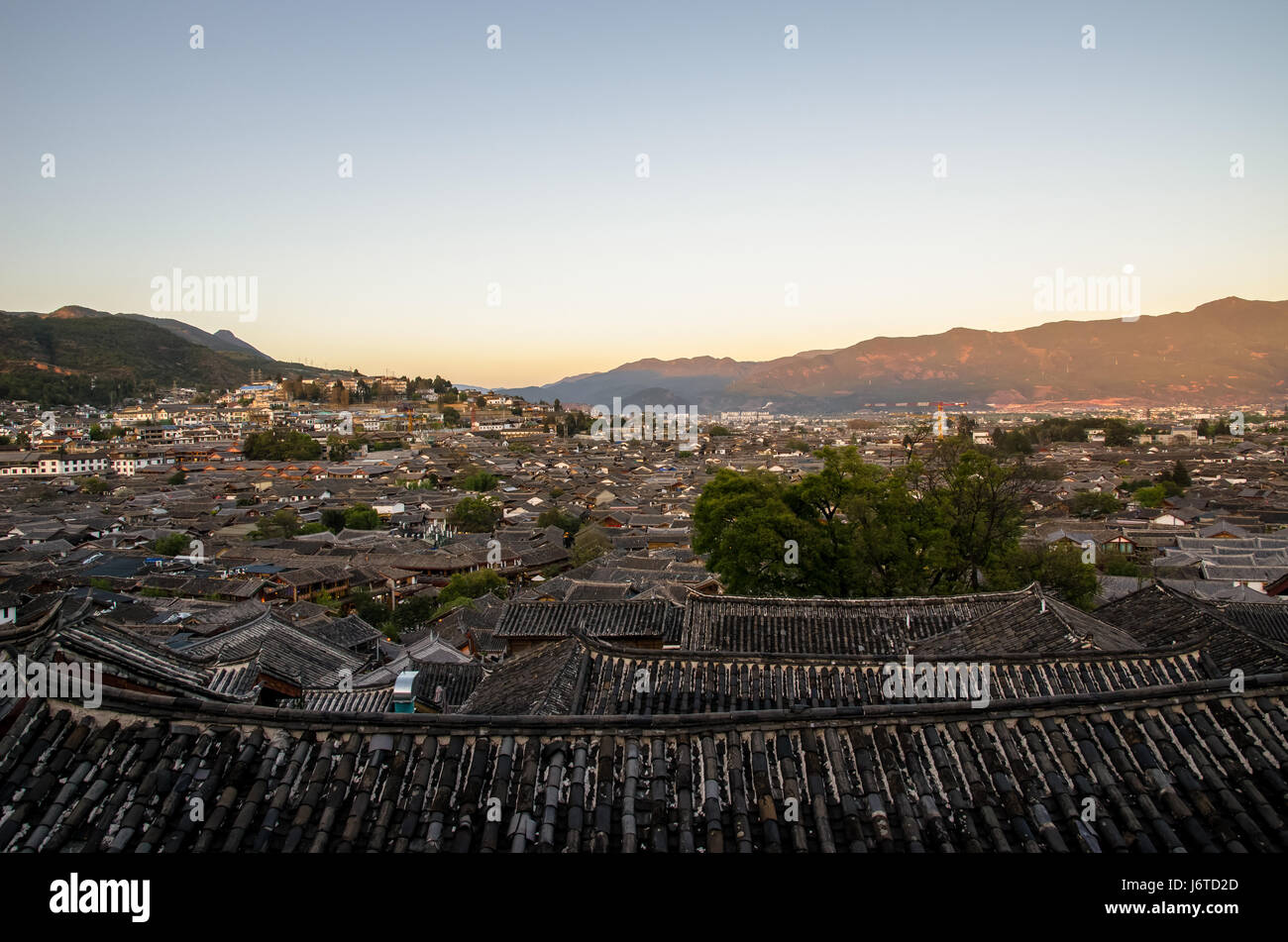 Evening bird eye view of local historical architecture roof building of Old Town of Lijiang in Yunnan, China. Stock Photo