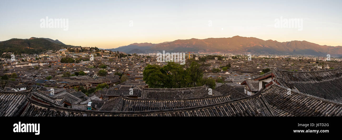 Evening bird eye view of local historical architecture roof building of Old Town of Lijiang in Yunnan, China. Stock Photo