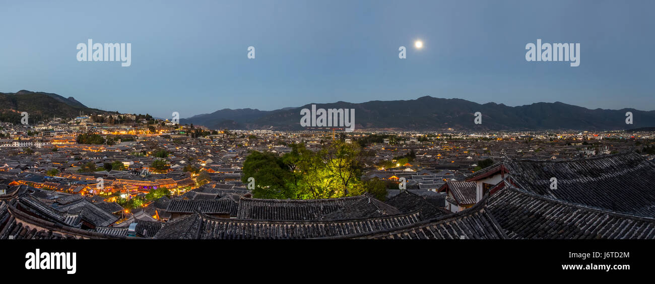Evening bird eye view of local historical architecture roof building of Old Town of Lijiang in Yunnan, China. Stock Photo