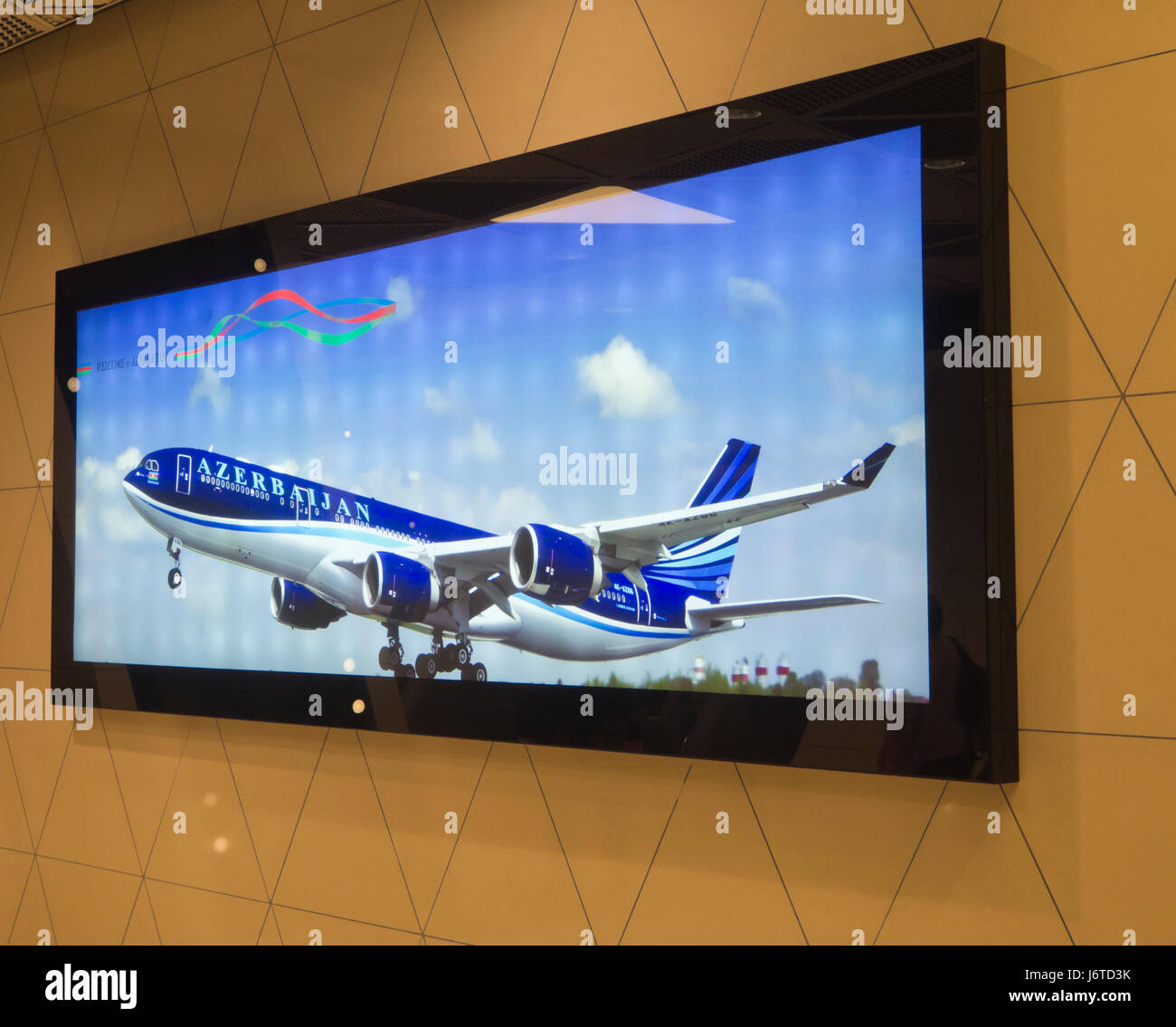 Heydar Aliyev International airport, Baku Azerbaijan, large led panel advertising the national airline in bright colours Stock Photo