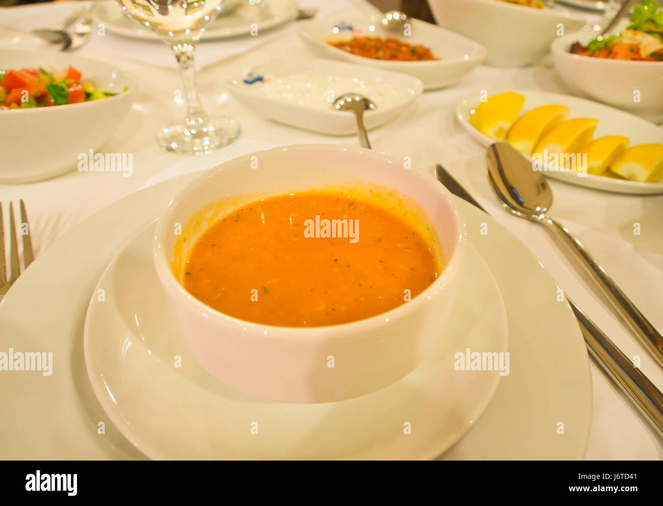 Fine dining in Baku Azerbaijan, red lentil soup and starters on an elegant table Stock Photo