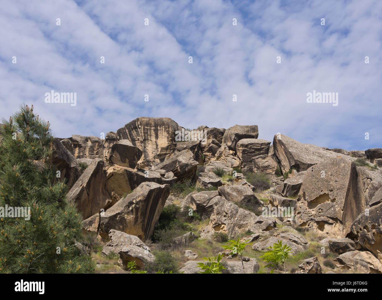 Gobustan National Park one hour south of Baku in Azerbaijan, offers stunning landscapes and 6000 ancient petroglyphs, weird rocks, sun and sky Stock Photo