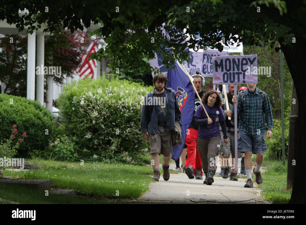 Harrisburg, PA., 21st May, 2017. A group of demonstrators, some of whom marched more than 100 miles from Philadelphia over the course of nine days, walk down a sidewalk near Hershey, PA, Sunday, May 21, 2017. The organizers plan on staging actions at the State Capitol building starting Monday, including planned civil disobedience. Credit: Michael Candelori/Alamy Live News Stock Photo