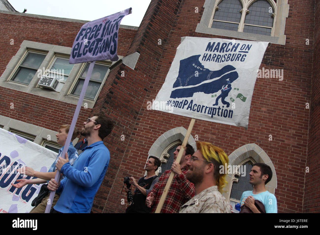 Harrisburg, PA., 21st May, 2017. A group of demonstrators, some of whom marched more than 100 miles from Philadelphia over the course of nine days, celebrate after arriving at the Unitarian Church of Harrisburg in Harrisburg, PA, Sunday, May 21, 2017. The organizers plan on staging actions at the State Capitol building starting Monday, including planned civil disobedience. Credit: Michael Candelori/Alamy Live News Stock Photo