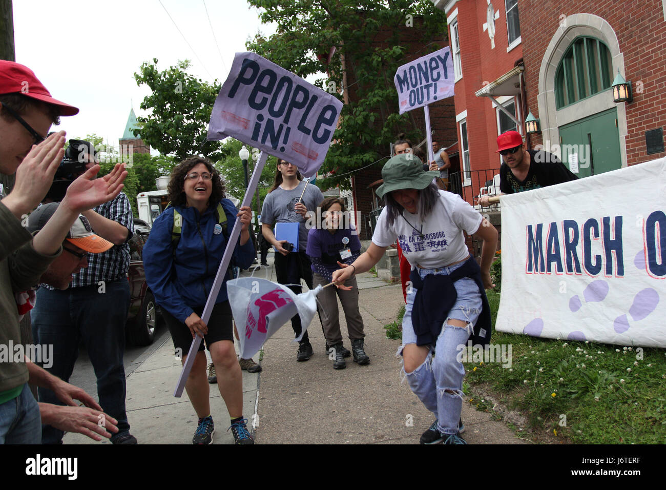 Harrisburg, PA., 21st May, 2017. A group of demonstrators, some of whom marched more than 100 miles from Philadelphia over the course of nine days, celebrate after arriving at the Unitarian Church of Harrisburg in Harrisburg, PA, Sunday, May 21, 2017. The organizers plan on staging actions at the State Capitol building starting Monday, including planned civil disobedience. Credit: Michael Candelori/Alamy Live News Stock Photo