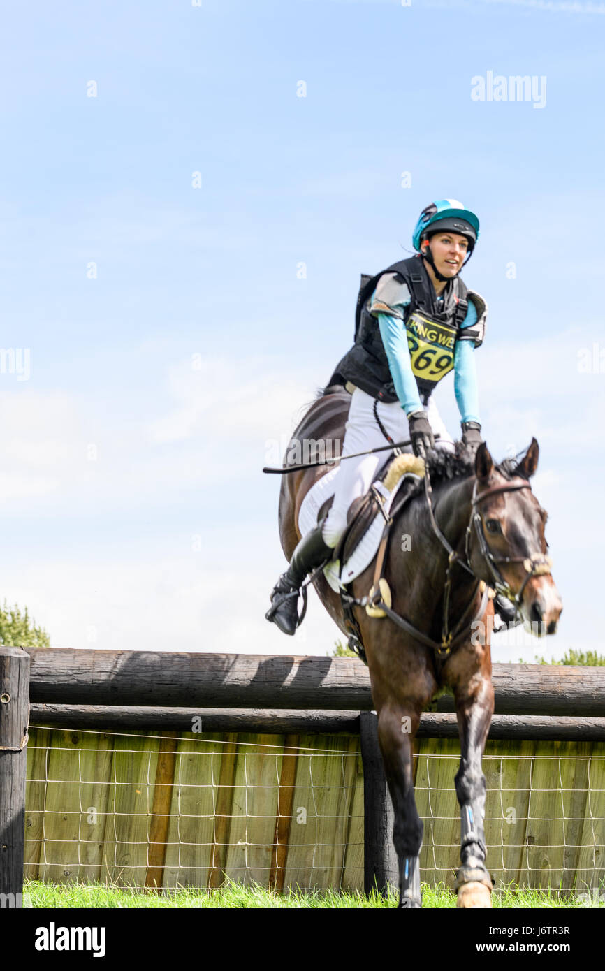 Rockingham Castle, Corby, UK. 21st May, 2017. Emma Stretton and her horse Willy Ever clear an obstacle on a sunny day during the cross country phase of the Rockingham International Horse Trials in the grounds of the Norman castle at Rockingham, Corby, England on 21st May 2017. Credit: miscellany/Alamy Live News Stock Photo