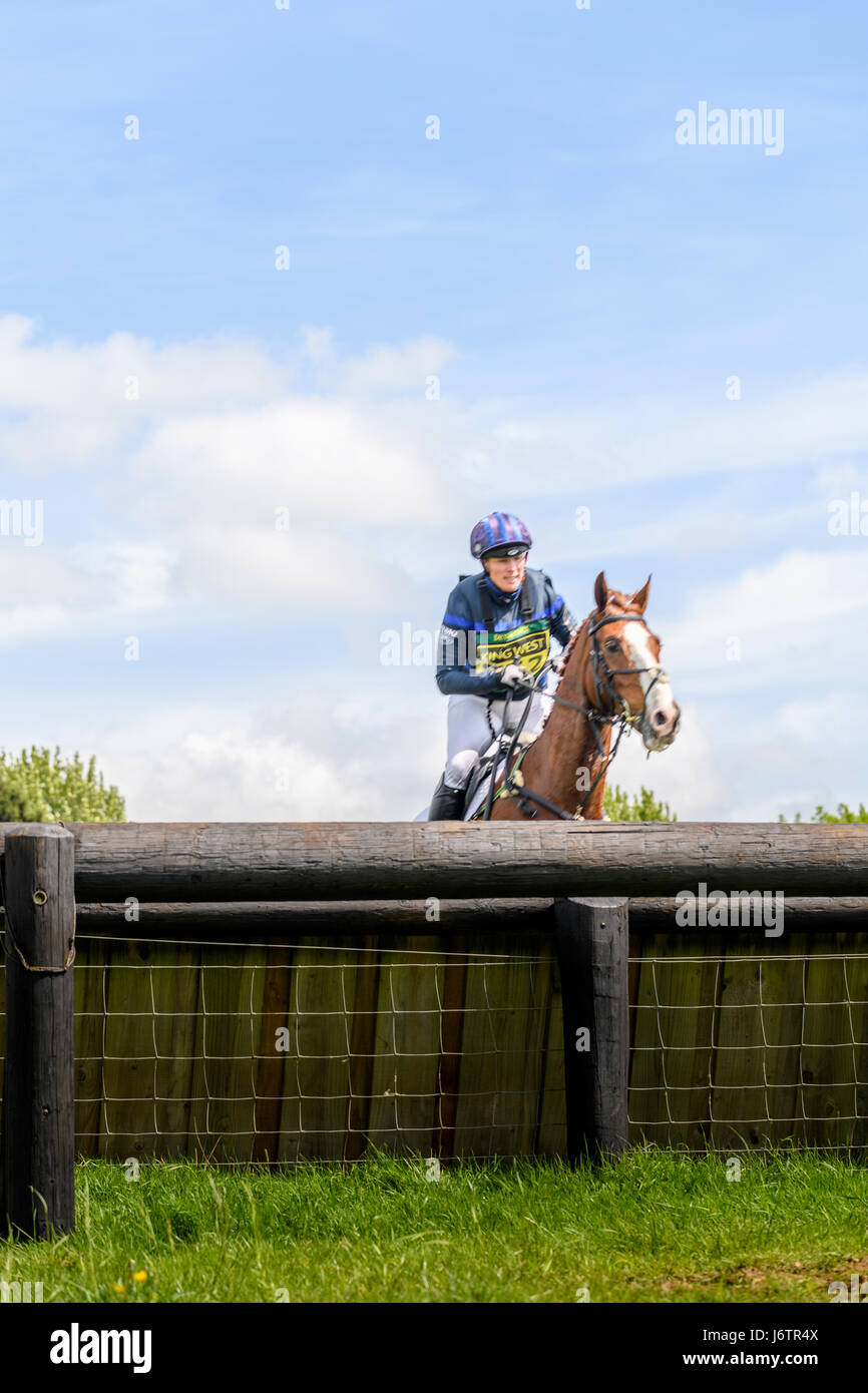 Rockingham Castle, Corby, UK. 21st May, 2017. Riding Big Class Affair, Zara Tindall (granddaughter of Queen Elizabeth II of the United Kingdom) clears a fence on a sunny day during the cross country phase of the Rockingham International Horse Trials in the grounds of the Norman castle at Rockingham, Corby, England on 21st May 2017. Credit: miscellany/Alamy Live News Stock Photo
