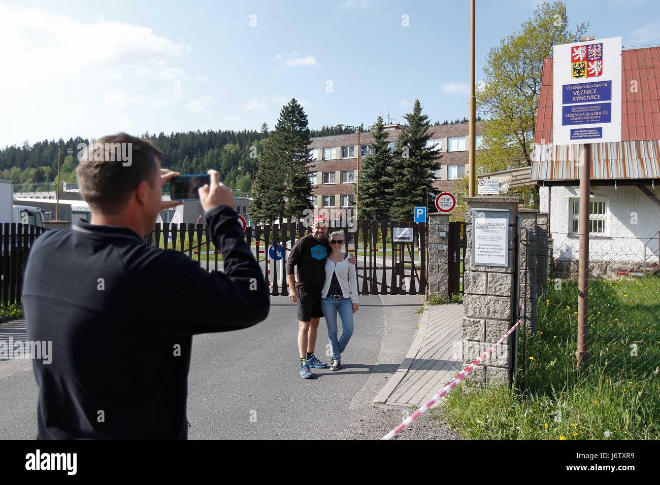 People take picture in front of the Rynovice prison in Jablonec nad Nisou, Czech Republic, May 21, 2017. Czech President Milos Zeman will grant pardon to Jiri Kajinek, who is serving life sentence for contract killing. Kajinek, 56, is probably the best-known Czech prisoner. He gained popularity mainly by his spectacular escape from Mirov, the country's toughest-security prison in north Moravia, in 2000. The police caught him after about six weeks on the run. A court in Plzen, west Bohemia, sentenced Kajinek to life on June 23, 1998. He was convicted of shooting businessman Stefan Janda and his Stock Photo