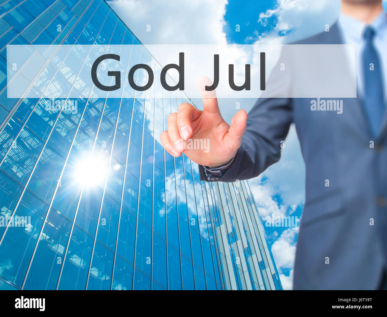 God Jul (Merry Christmas in Swedish) - Businessman hand pressing button on touch screen interface. Business, technology, internet concept. Stock Photo Stock Photo