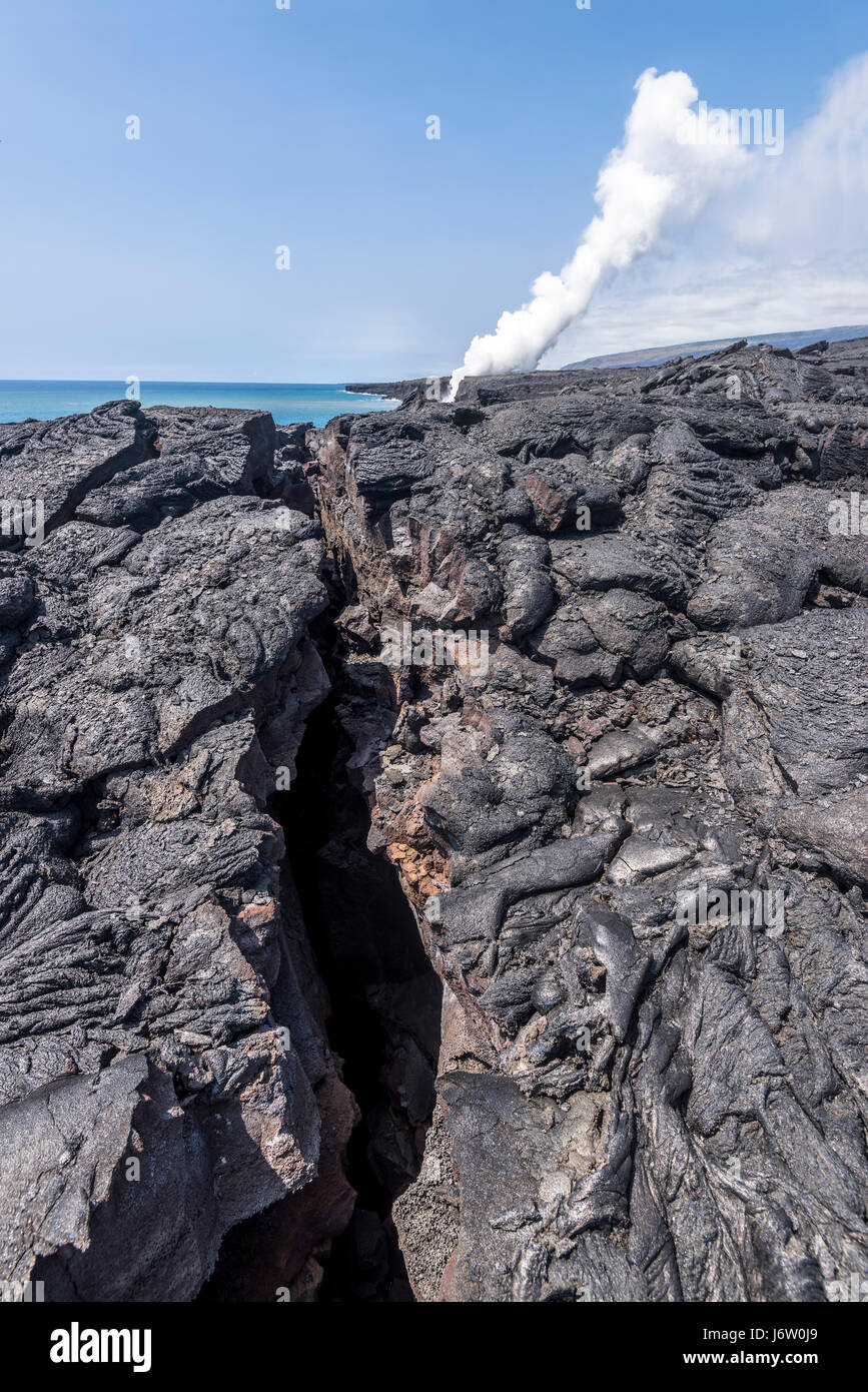 A long volcanic surface fissure formed from Kilauea volcano in Hawaii shows the devastation eruptions cause. Stock Photo