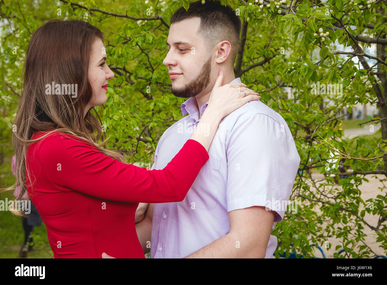 Happy young couple expecting baby in summer park Stock Photo - Alamy