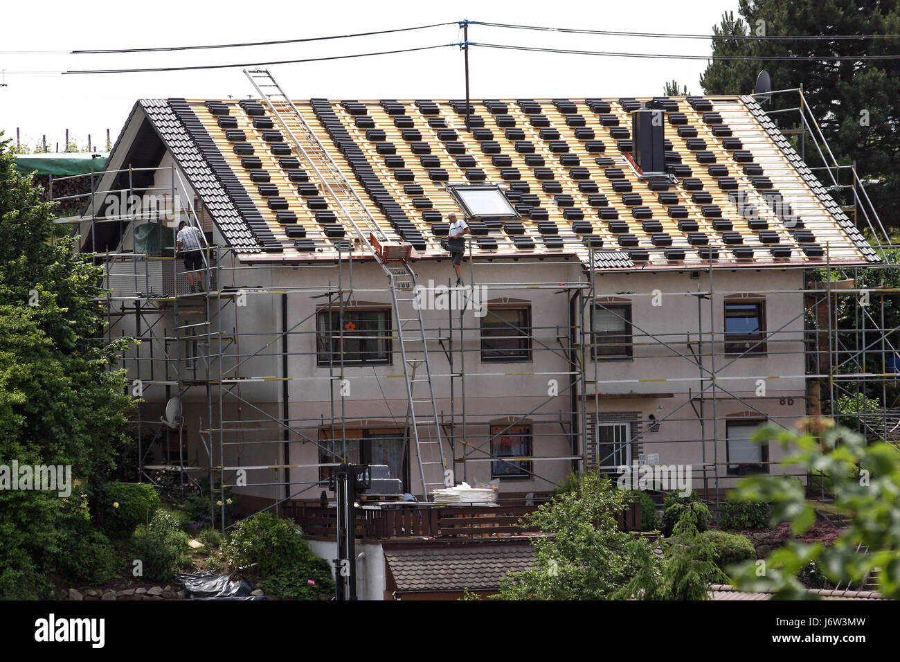 brick scaffold scaffolding tile tiler building industry modernization rooftop Stock Photo
