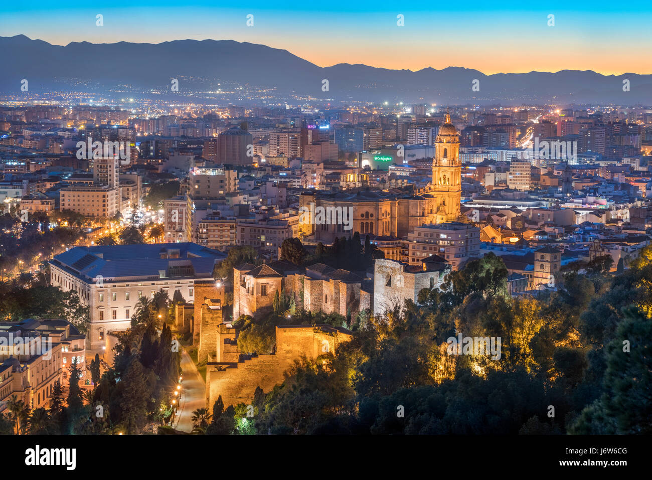 Malaga Cathedral with Old Town scenic view from Gibralfaro with the Alcazaba castle at sunset twilight dusk evening bhz Stock Photo