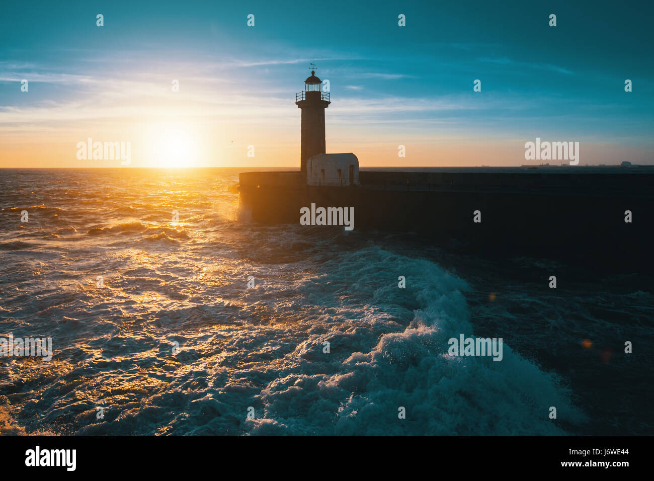 Stunning sunset on the ocean the lighthouse Stock Photo - Alamy