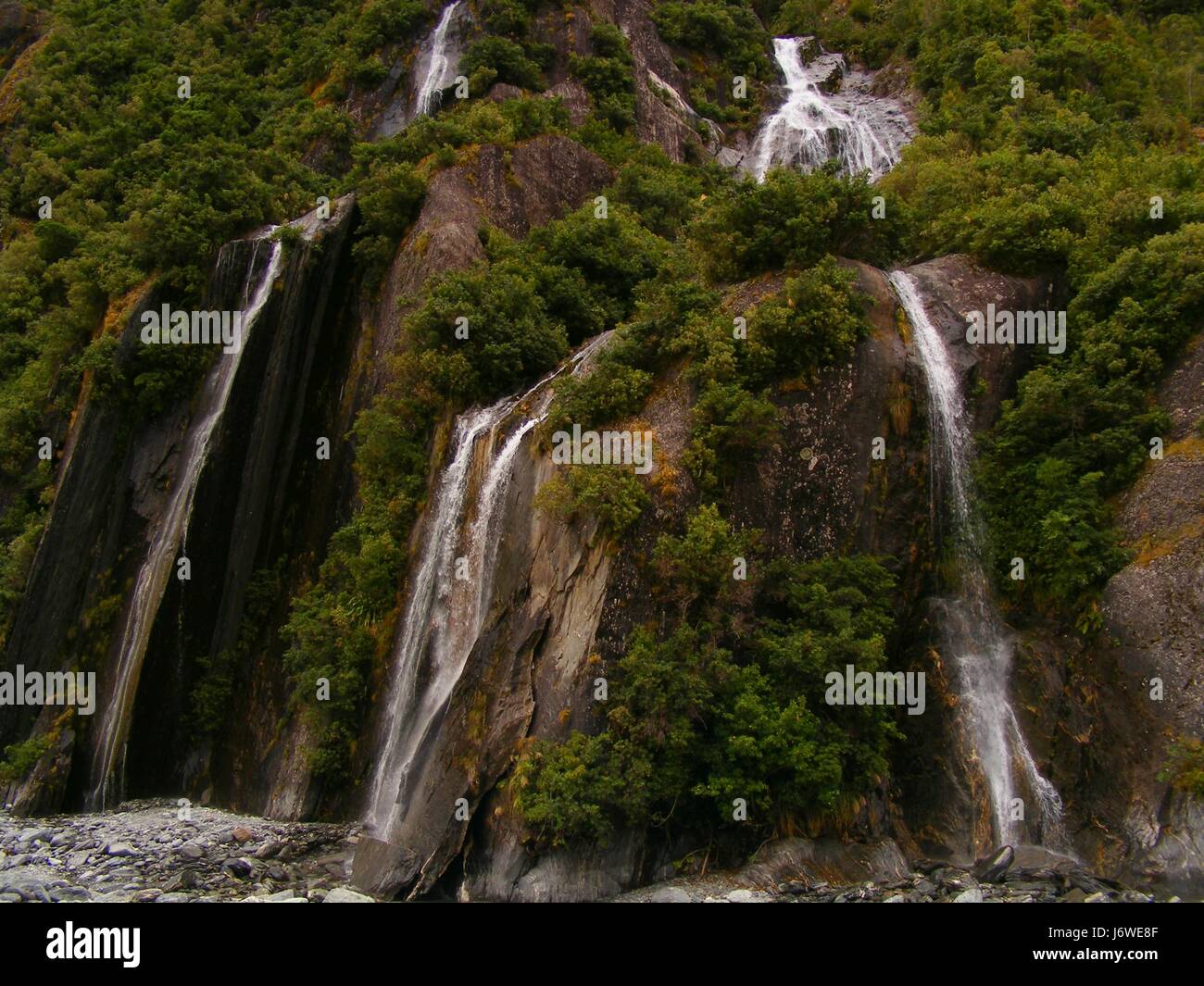 waterfall valley new zealand steep torrent group mountain blue