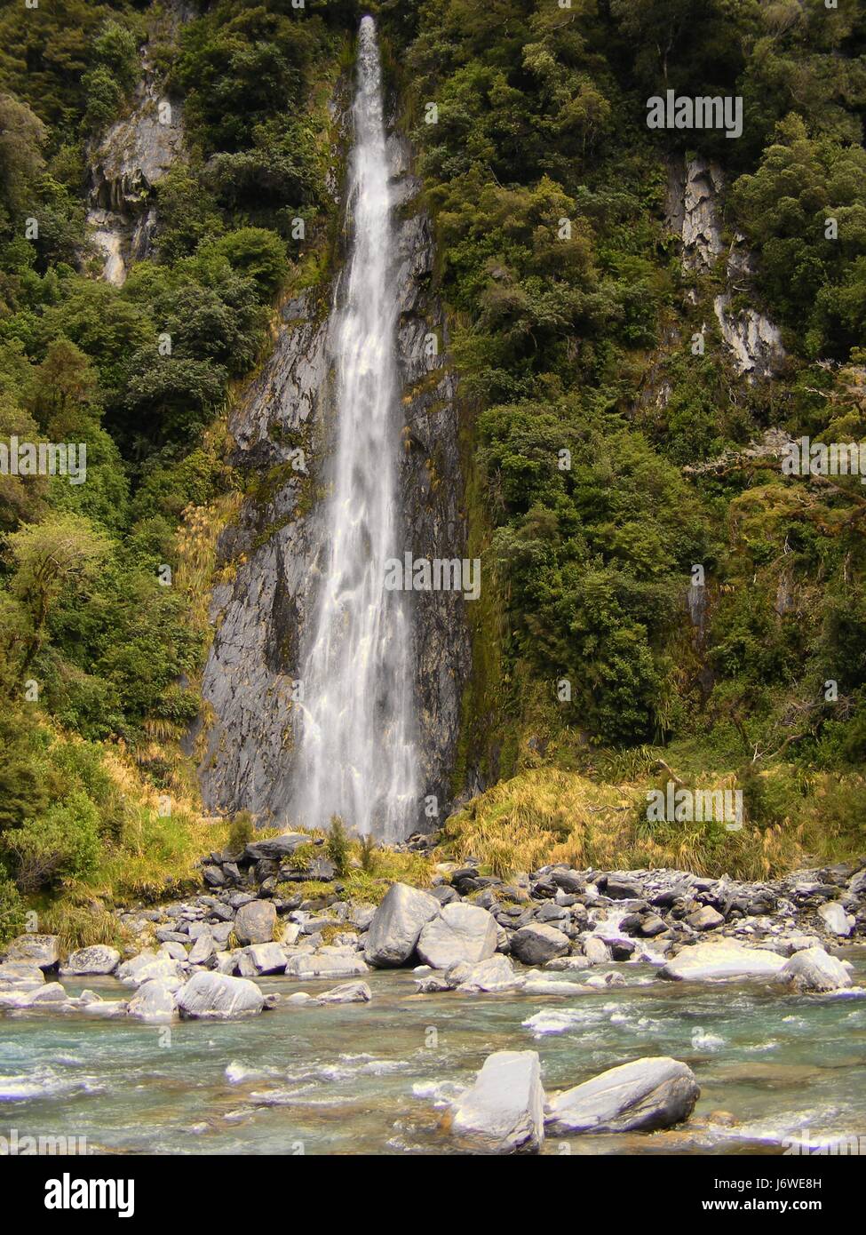 waterfall valley new zealand steep torrent group mountain blue