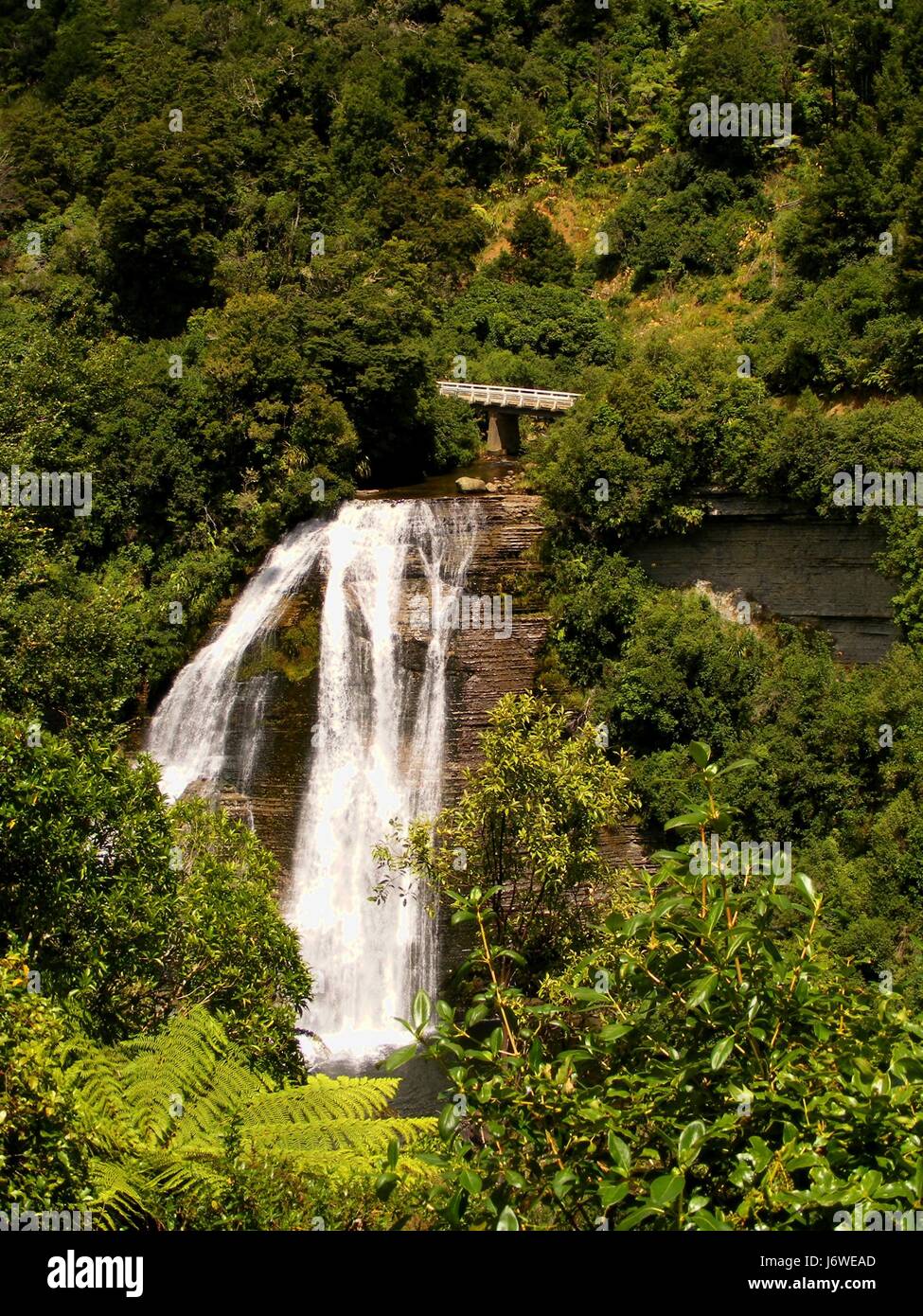 waterfall valley new zealand steep torrent group mountain blue