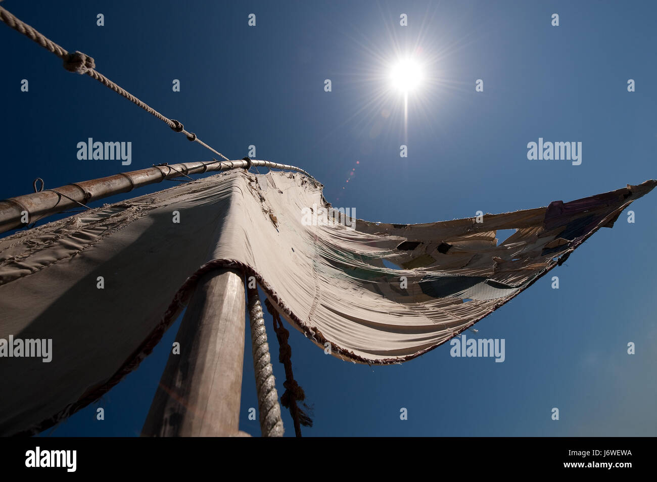 sail mast sailing boat sailboat tense salt water sea ocean water shine