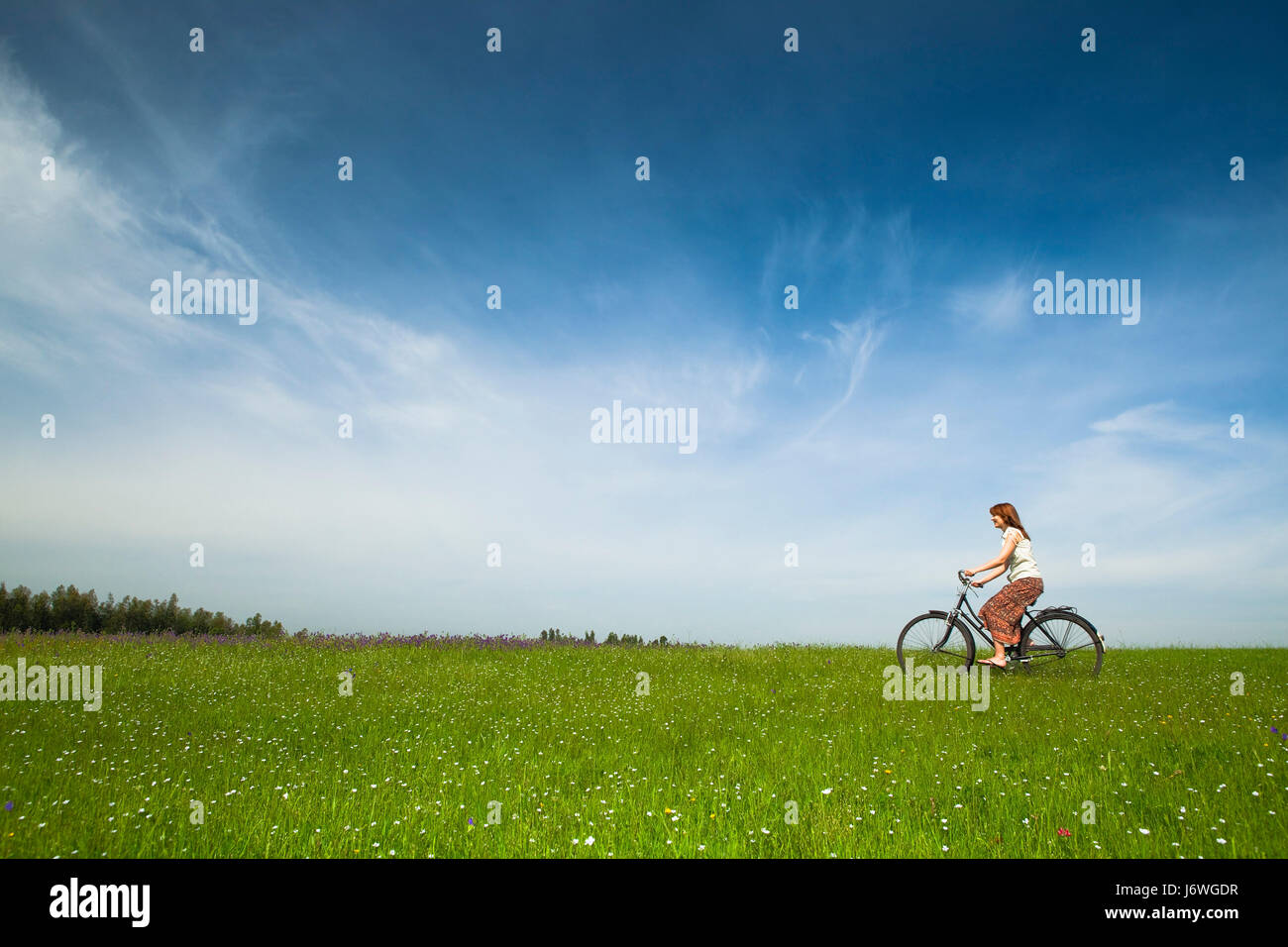 woman field spring bouncing bounces hop skipping frisks jumping jump ...