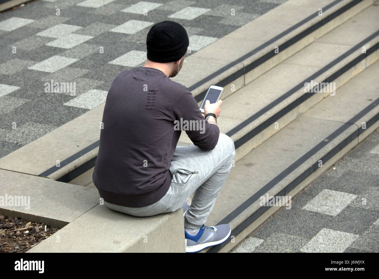 trendy young man teenager on smartphone Stock Photo