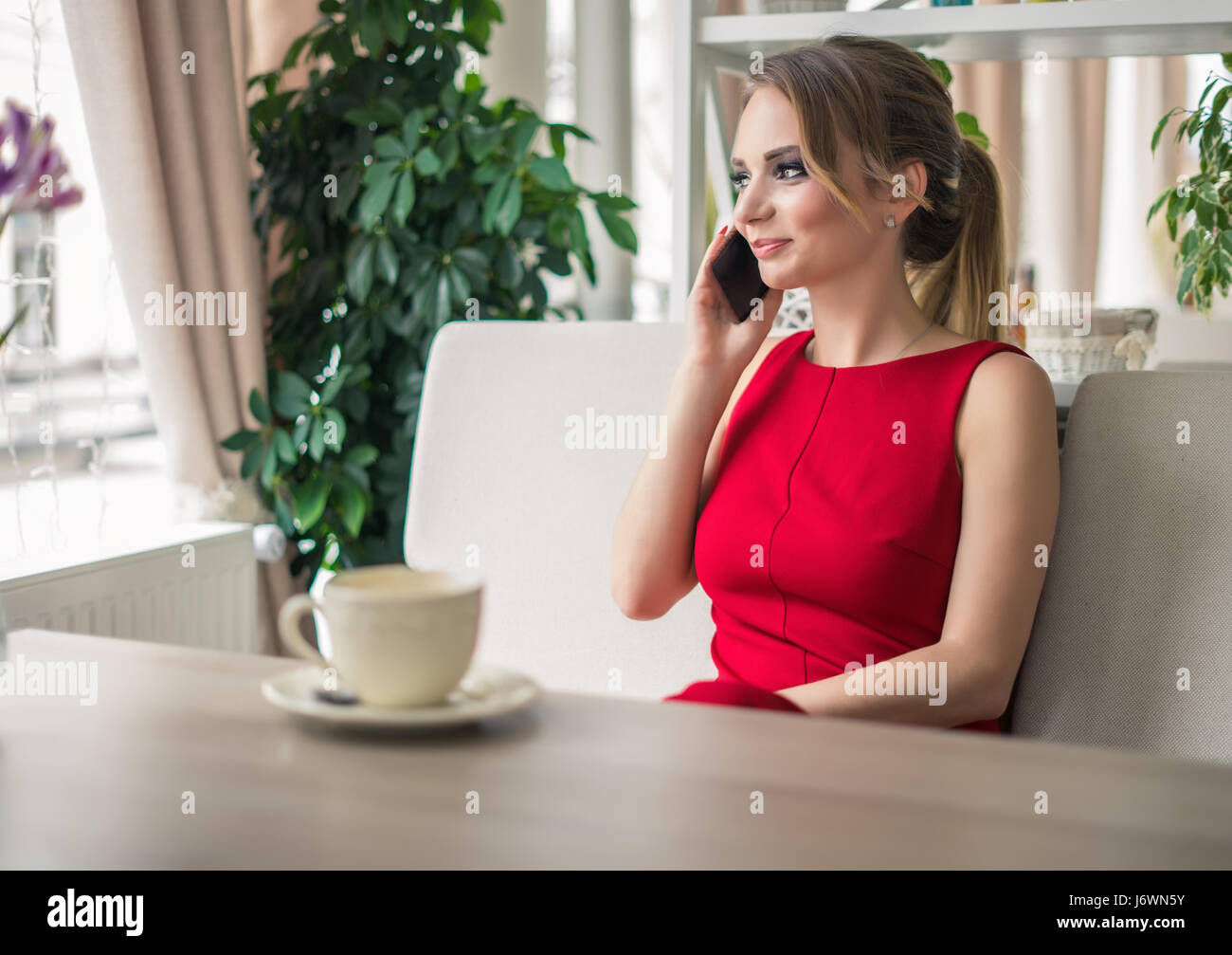 Businesswoman speaking on smartphone taking a coffee break Stock Photo ...