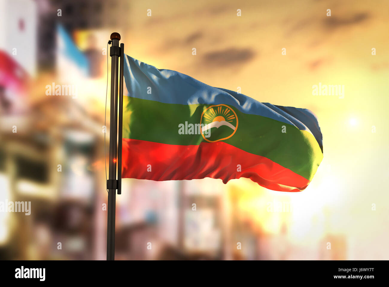 Karachay-Cherkessia Flag Against City Blurred Background At Sunrise Backlight Stock Photo