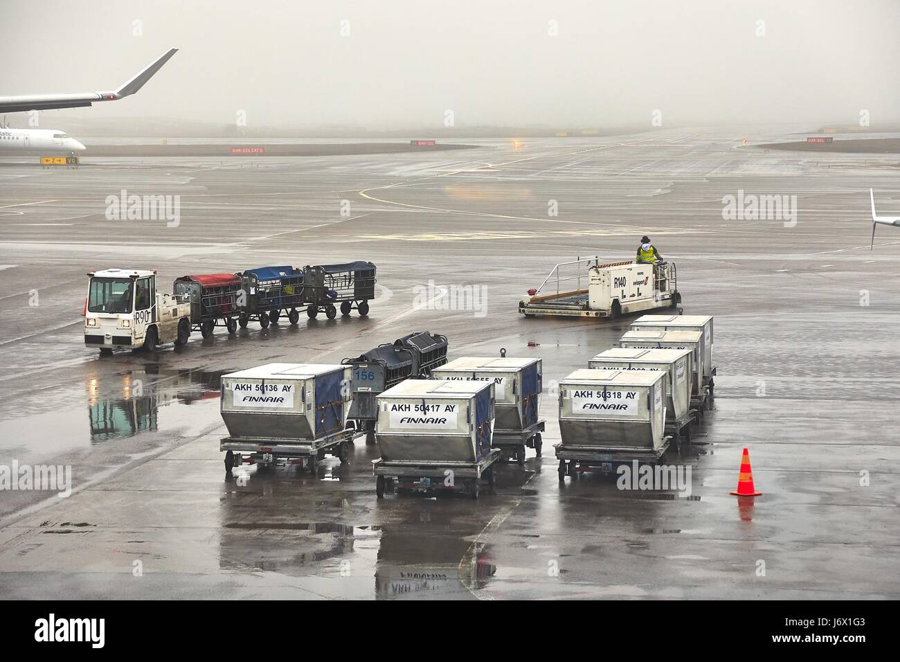 HELSINKI, FINLAND - APRIL 1, 2017: Air cargo unit load devices at Helsinki Internation Airport. Foggy, rainy weather. Stock Photo