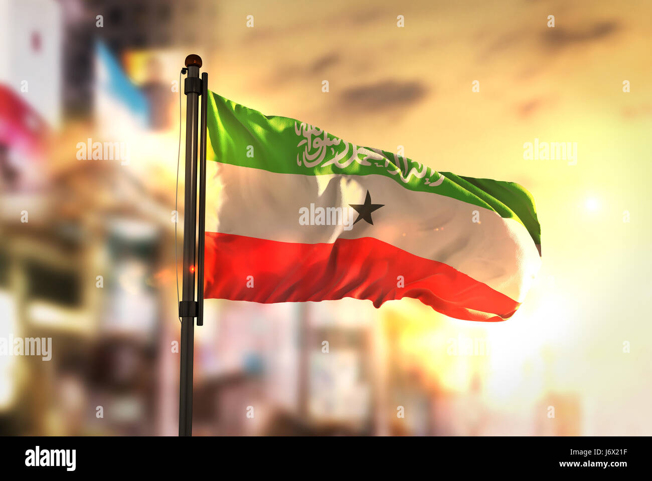 Somaliland Flag Against City Blurred Background At Sunrise Backlight Stock Photo