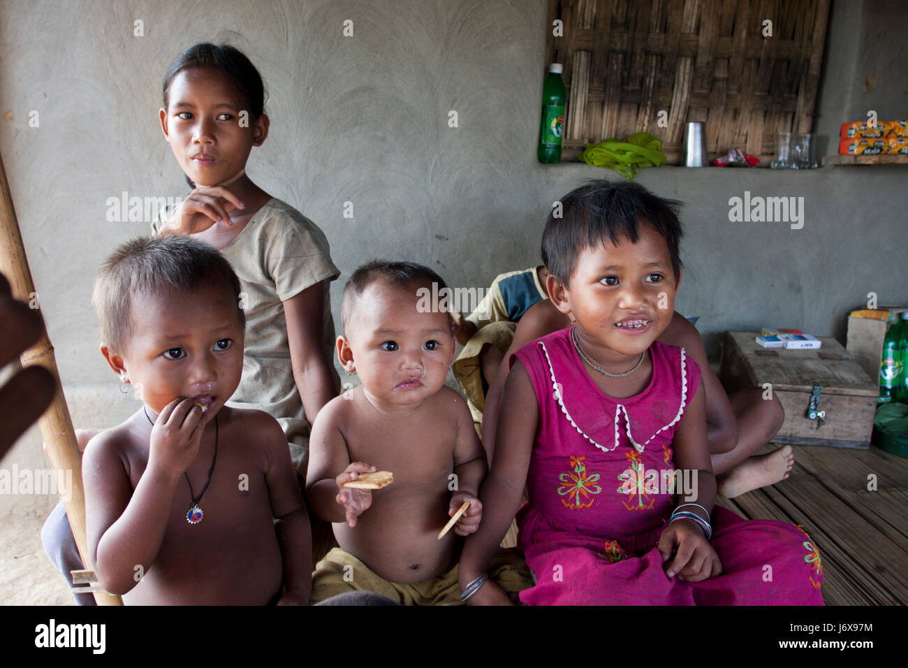 Children of the ethnic family staying at their home. Khagrachari, Bangladesh. Stock Photo