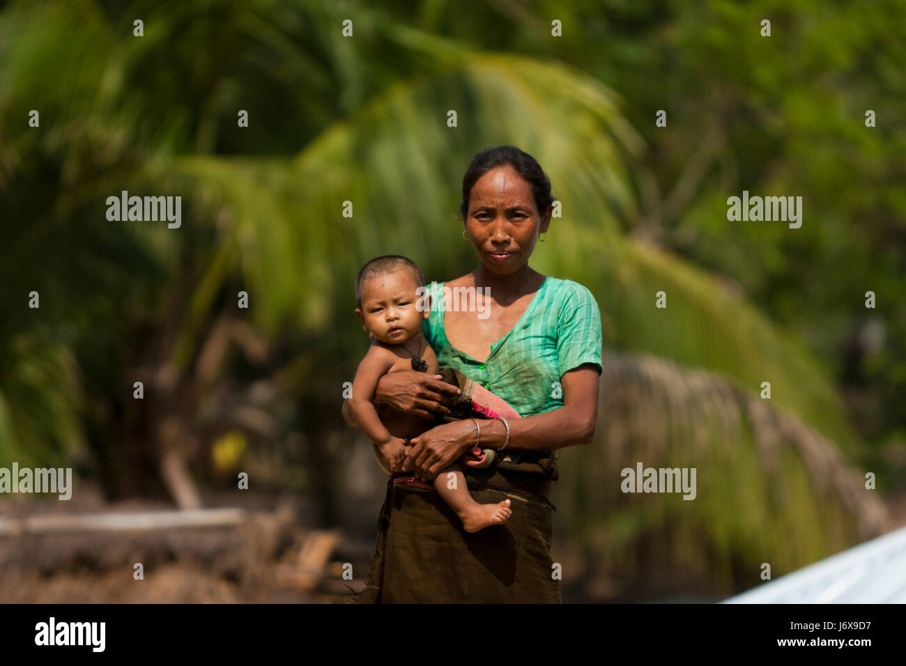 An ethnic woman holds a baby. Khagrachari, Bangladesh. Stock Photo