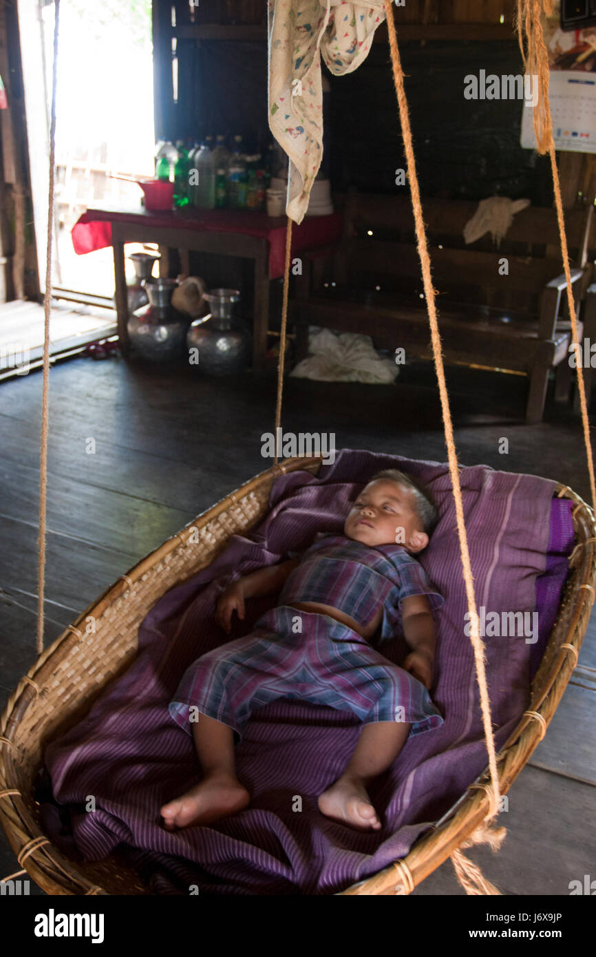 An ethnic baby sleeps on the cradle. Khagrachari, Bangladesh. Stock Photo