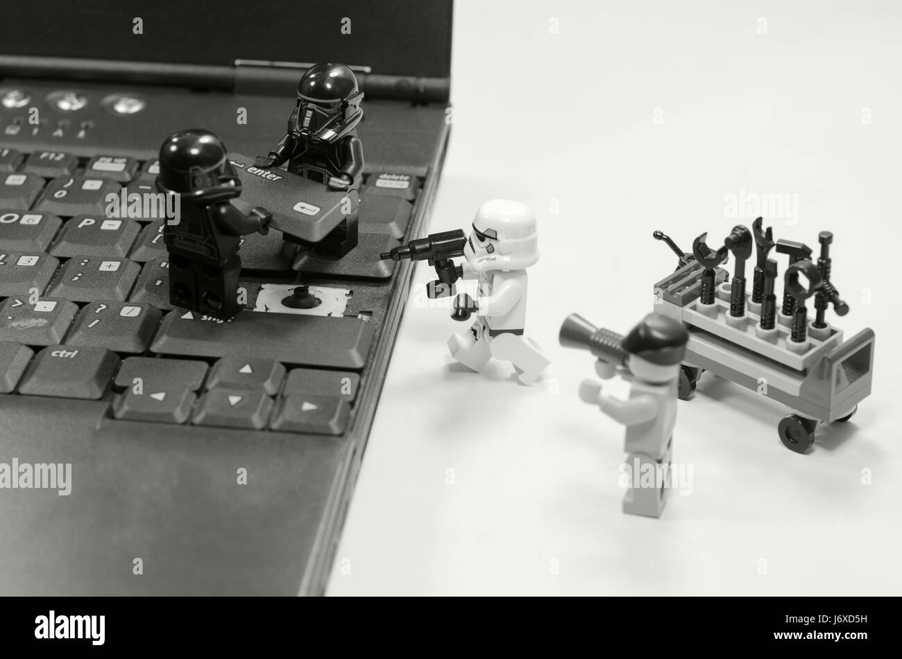 lego star wars minifigures repair button enter on laptop keyboard.black and white image. Stock Photo