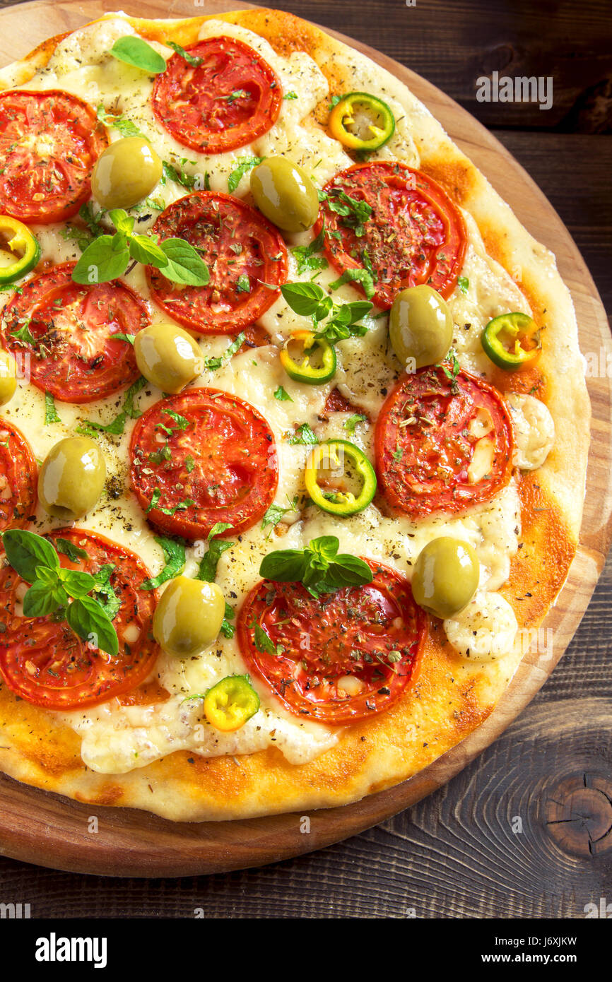 Italian Pizza with Tomatoes, Pepper, green Olives, Oregano and