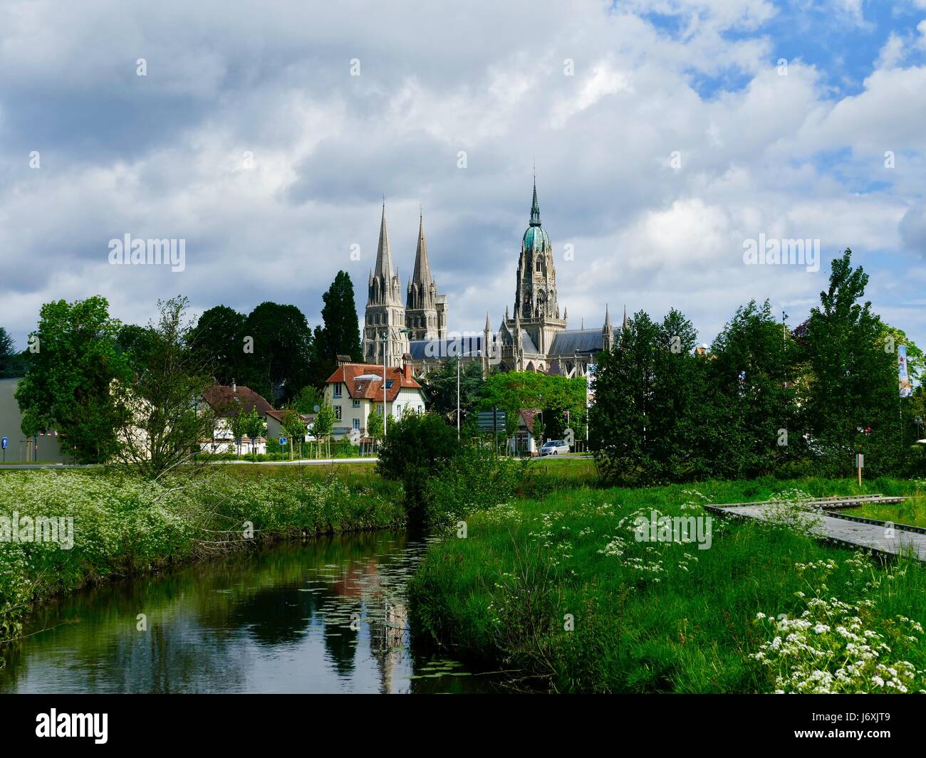 View of Bayeux Cathedral, Cathédrale Notre-Dame de Bayeux, across the green marshland of Vallée de l'Aure, Bayeux, Calvados, France Stock Photo