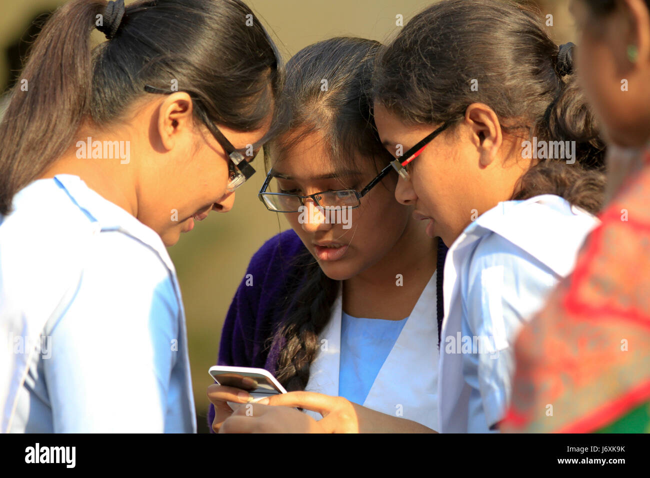 Students of Viqarunnisa Noon School and College search for results using mobile phone after the Junior School Certificate (JSC) examination results ar Stock Photo