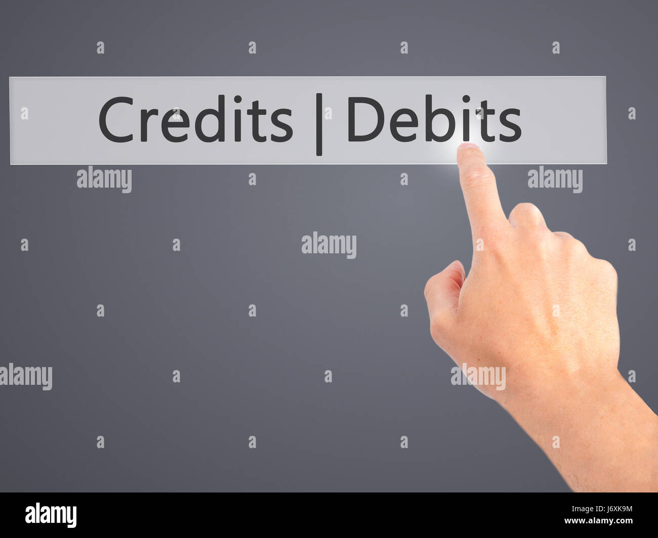 Credits Debits - Hand pressing a button on blurred background concept ...