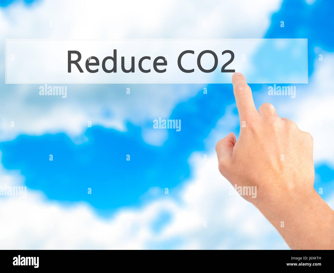 Reduce CO2 - Hand pressing a button on blurred background concept ...