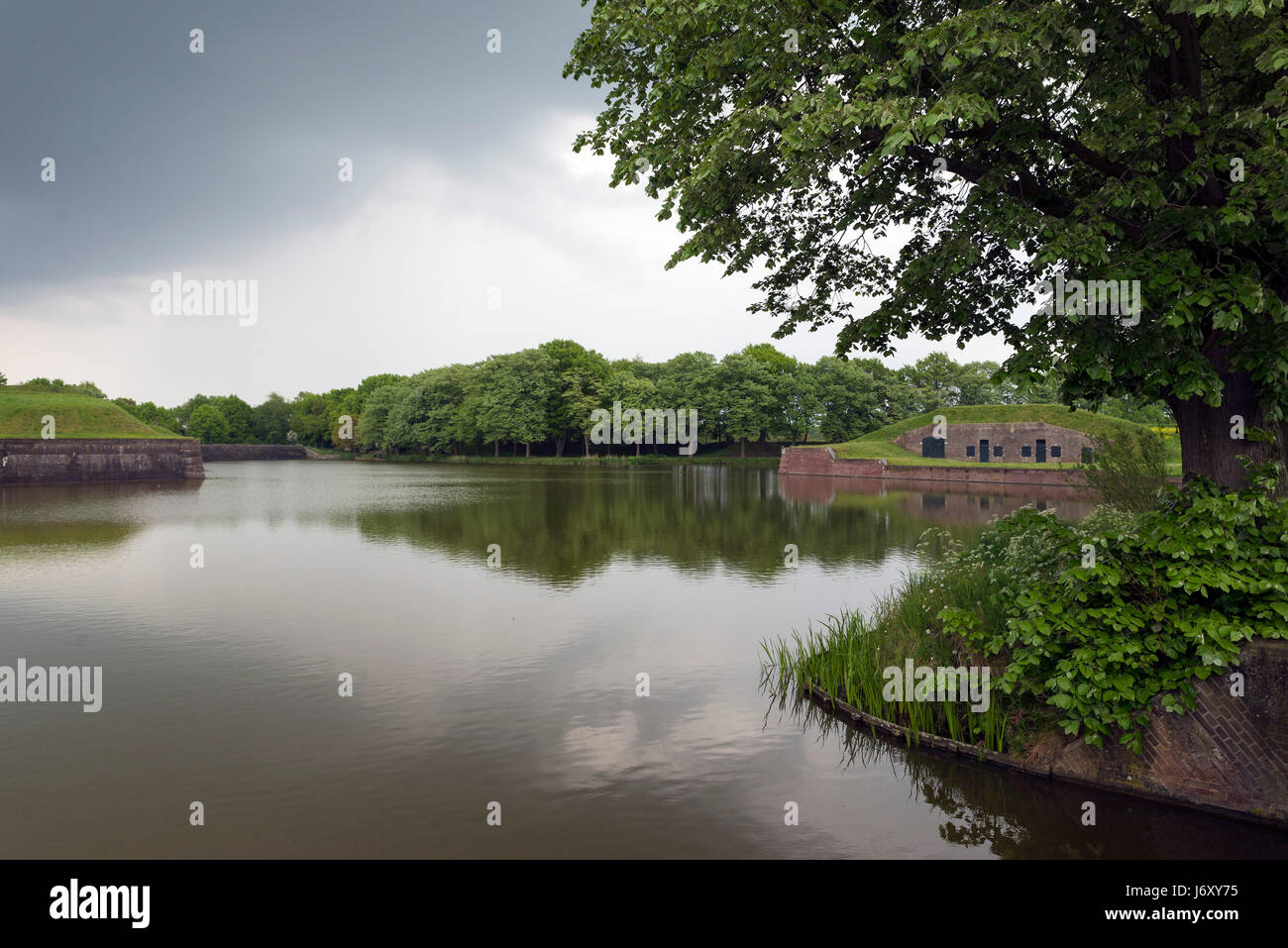 NAARDEN - NETHERLANDS - MAY 13, 2017: Naarden is an example of a star fort, complete with fortified walls and a moat. The moat and walls have been res Stock Photo