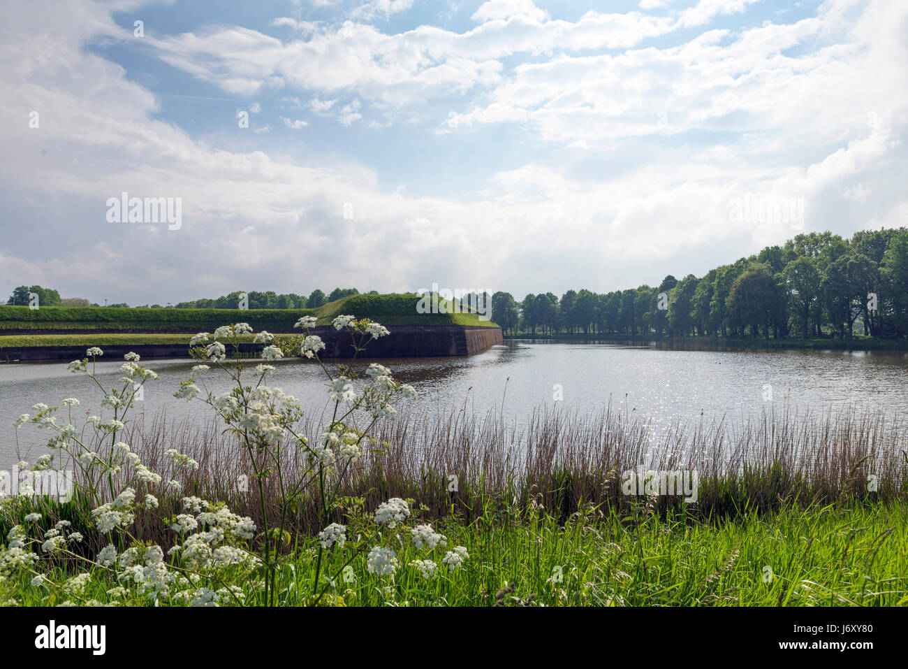 NAARDEN - NETHERLANDS - MAY 13, 2017: Naarden is an example of a star fort, complete with fortified walls and a moat. The moat and walls have been res Stock Photo