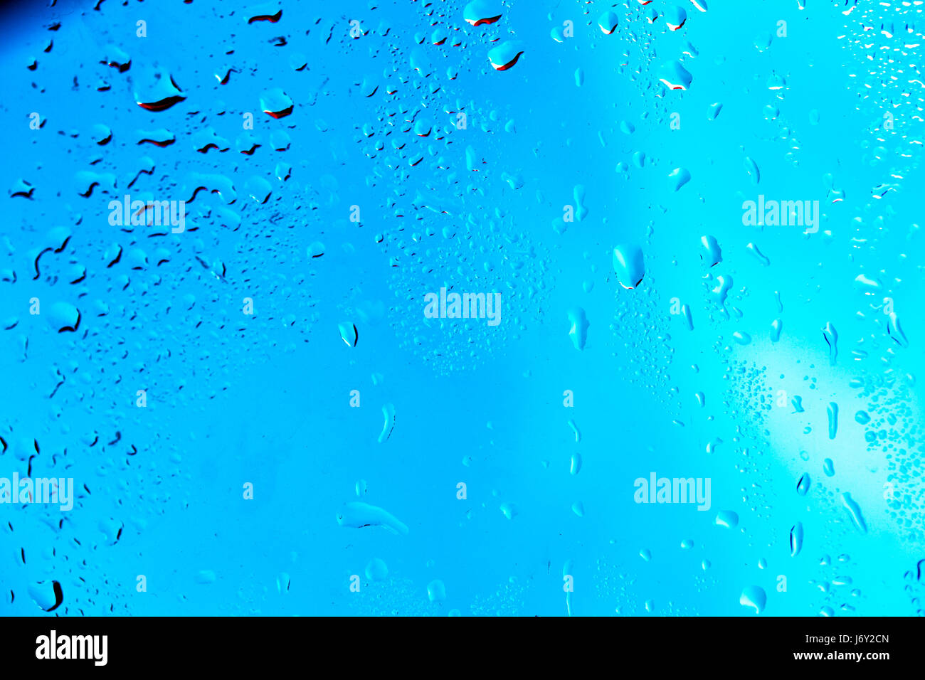 Drops on the glass rain blue background Stock Photo - Alamy