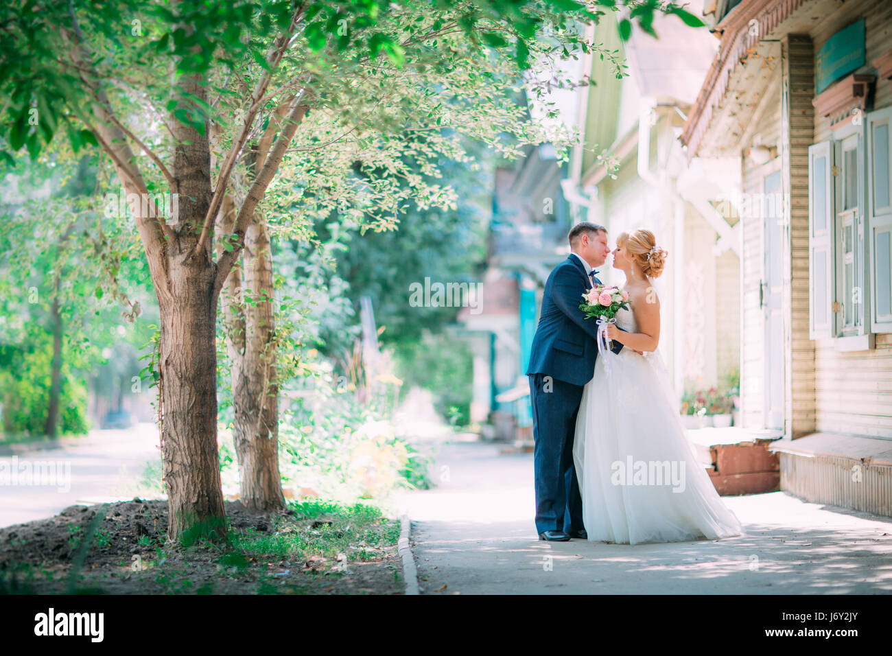 bride and groom on the background of the city Stock Photo - Alamy
