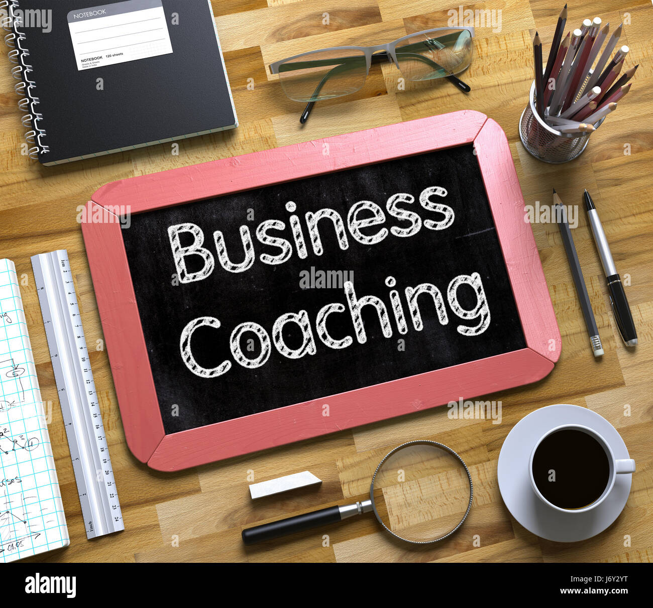 Business Coaching - Text on Small Chalkboard. 3D. Stock Photo