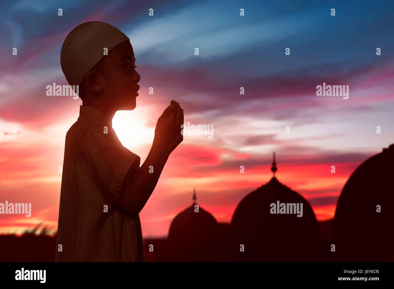 Portrait Of Asian Muslim Child Raising Hand And Praying Over