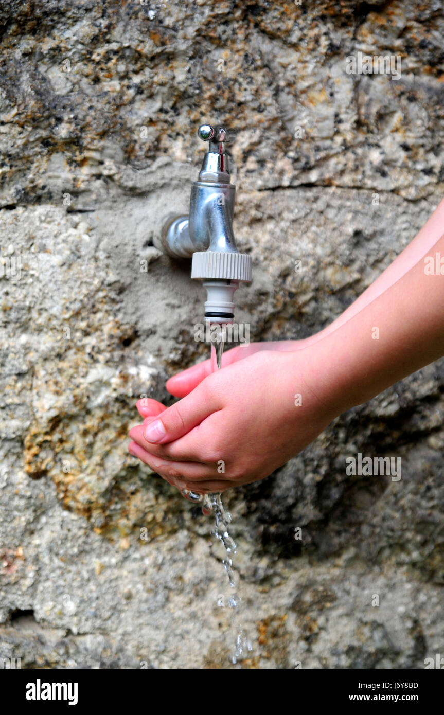 hand hands wet tap moist water hand hands stone save wet tap drinking water Stock Photo Alamy